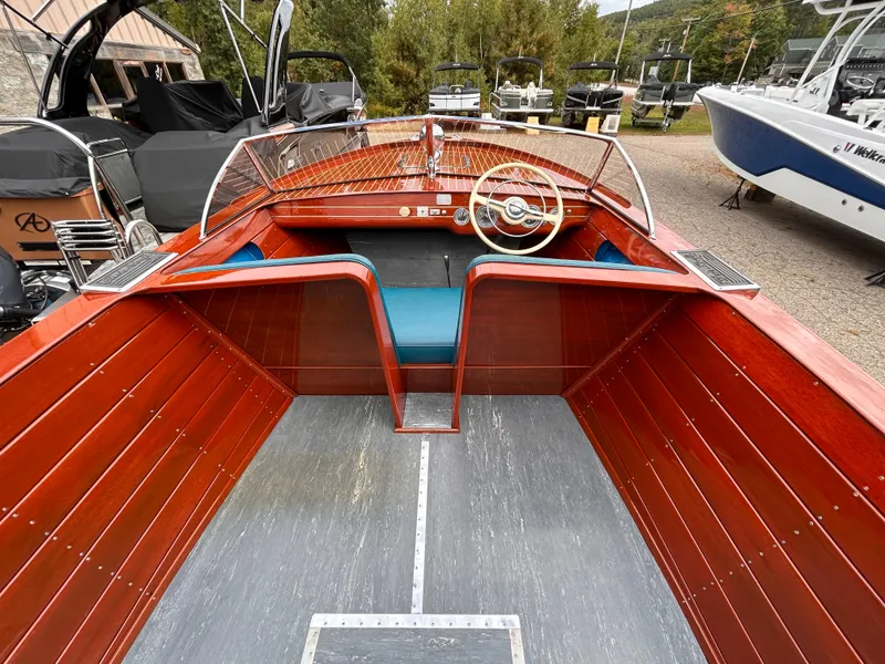 Slide: The Image of 1953 Chris-Craft 22 Sportsman boat with wooden interior and classic steering wheel. - 23