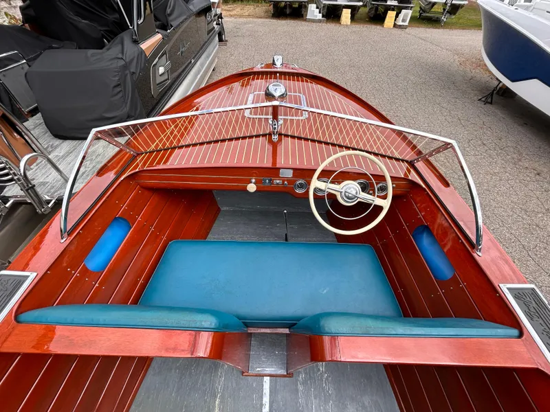 Slide: The Image of 1953 Chris-Craft 22 Sportsman boat with wooden deck and blue seating. - 26