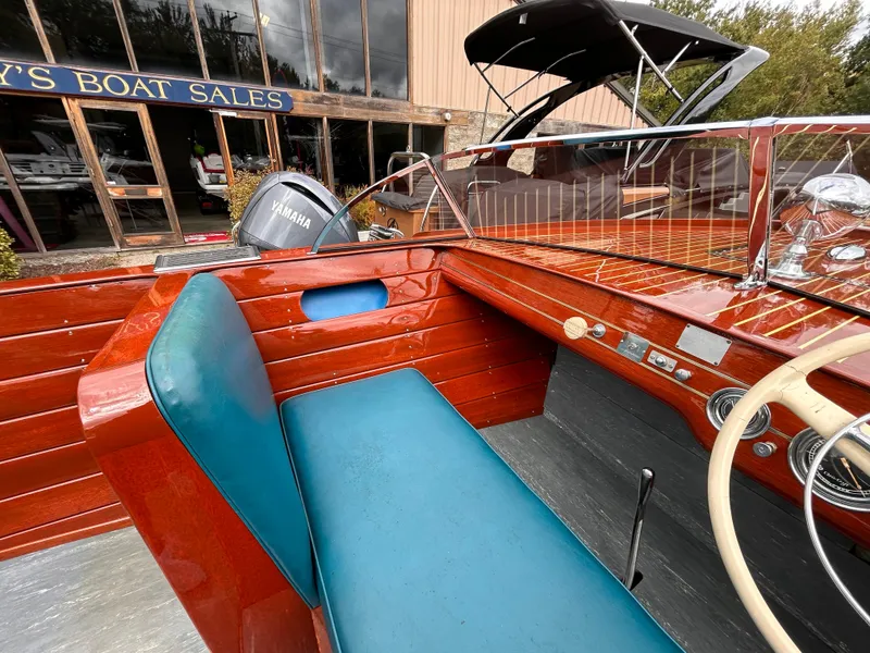 Slide: The Image of 1953 Chris-Craft 22 Sportsman boat interior with blue seating at a boat sales shop. - 27