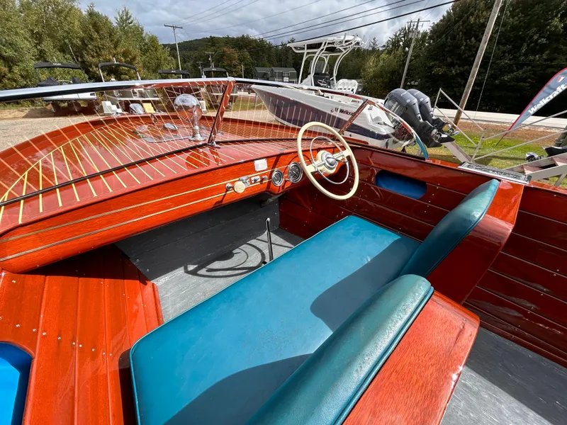 Slide: The Image of 1953 Chris-Craft 22 Sportsman boat interior with wooden dashboard and blue seating. - 28