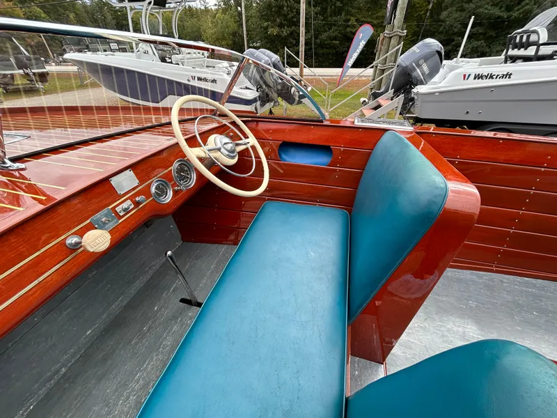 Slide: The Image of 1953 Chris-Craft 22 Sportsman boat interior with blue seats and wooden dashboard. - 29