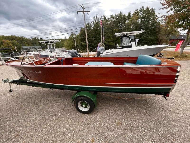 Slide: The Image of 1953 Chris-Craft 22 Sportsman boat on trailer, classic wooden design, outdoor setting. - 3