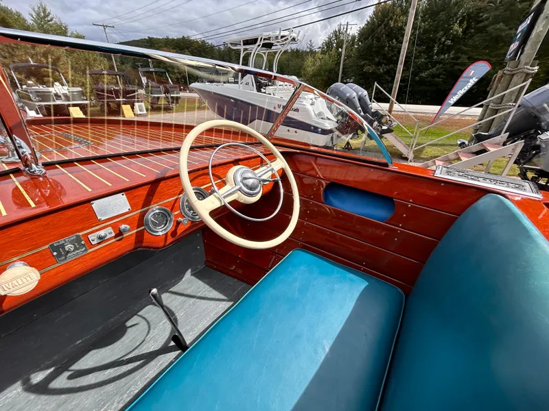 Slide: The Image of 1953 Chris-Craft 22 Sportsman boat interior with vintage steering wheel and blue seating. - 30