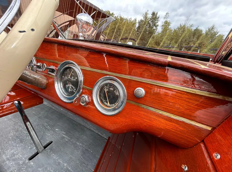 Slide: The Image of 1953 Chris-Craft 22 Sportsman dashboard with vintage gauges and wooden finish. - 32