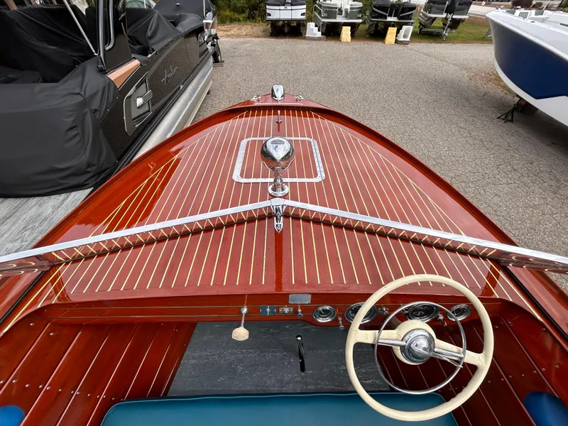 Slide: The Image of 1953 Chris-Craft 22 Sportsman boat with polished wood finish and classic steering wheel. - 34