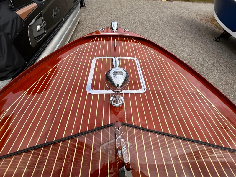 Slide: The Image of 1953 Chris-Craft 22 Sportsman boat with polished wooden deck and chrome details. - 35