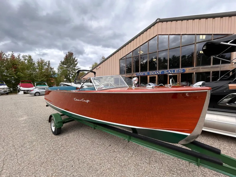 Slide: The Image of 1953 Chris-Craft 22 Sportsman boat on trailer outside sales building. - 4