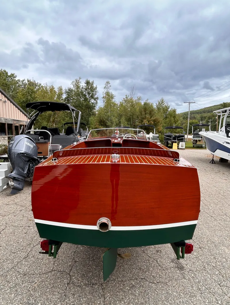 Slide: The Image of 1953 Chris-Craft 22 Sportsman boat with polished wood finish, parked outdoors. - 8