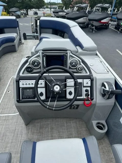 Slide: The Image of 2023 Berkshire 24ULE-STS3 boat dashboard with steering wheel and control panel. - 3