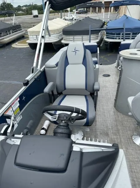 Slide: The Image of 2023 Berkshire 24ULE-STS3 pontoon boat interior with steering console and seating. - 4