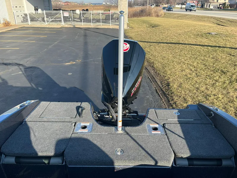 Slide: The Image of 2025 Lund 189 Tyee GL boat with motor, parked on pavement. - 10