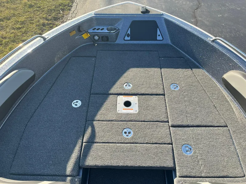 Slide: The Image of 2025 Lund 189 Tyee GL boat deck with storage compartments and seating area. - 16