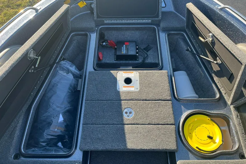 Slide: The Image of 2025 Lund 189 Tyee GL boat interior with storage compartments and equipment. - 17