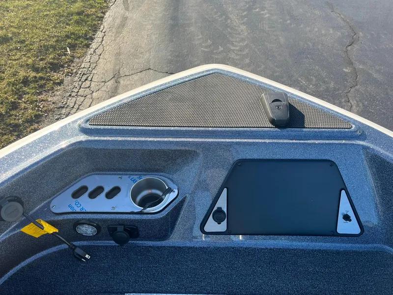 Slide: The Image of 2025 Lund 189 Tyee GL boat dashboard with control panel and cup holder. - 18