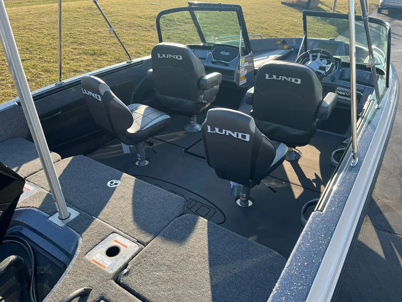 Slide: The Image of 2025 Lund 189 Tyee GL boat interior with four seats and steering console. - 19