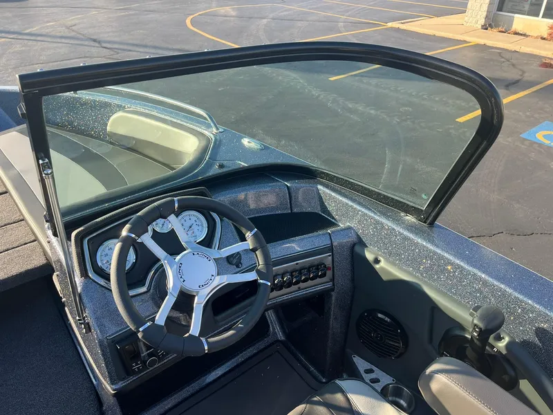 Slide: The Image of 2025 Lund 189 Tyee GL boat dashboard with steering wheel and controls. - 20