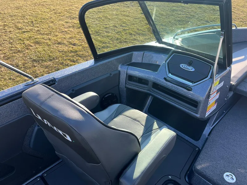 Slide: The Image of 2025 Lund 189 Tyee GL boat interior with seating and dashboard. - 21