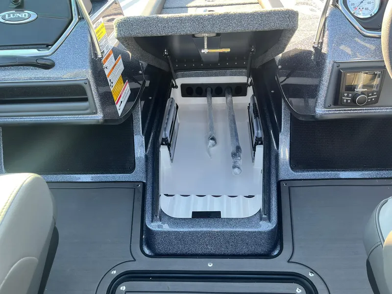 Slide: The Image of 2025 Lund 189 Tyee GL boat interior with open storage compartment. - 23