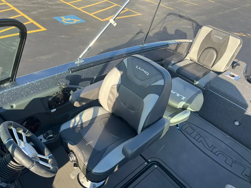 Slide: The Image of 2025 Lund 189 Tyee GL boat interior with comfortable seating and steering wheel. - 25