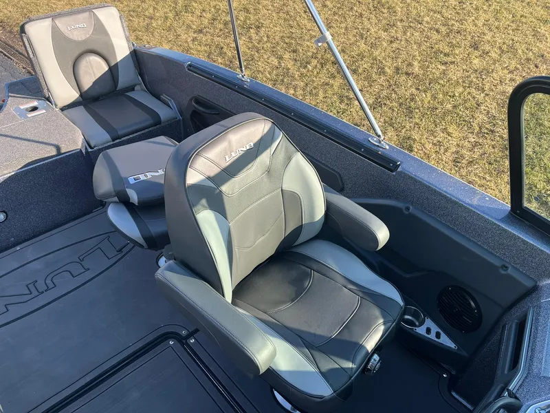 Slide: The Image of 2025 Lund 189 Tyee GL boat interior with comfortable seating and modern design. - 26