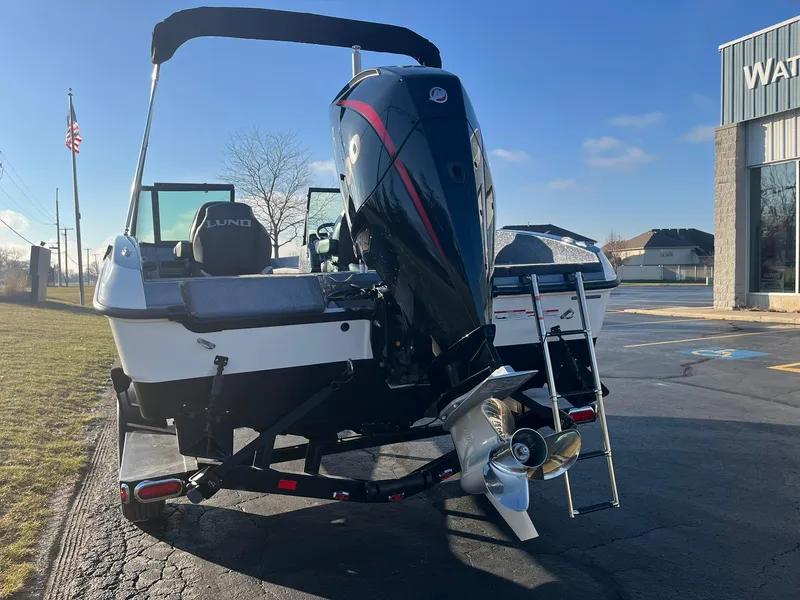 Slide: The Image of 2025 Lund 189 Tyee GL boat with powerful outboard motor, parked outdoors. - 4