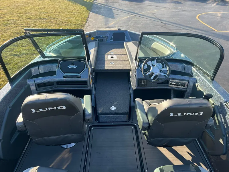 Slide: The Image of 2025 Lund 189 Tyee GL boat interior with dual seats and steering console. - 6