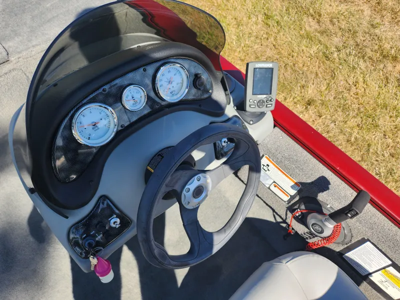 Slide: The Image of 2018 Tracker Pro 170 boat dashboard with steering wheel and gauges. - 11