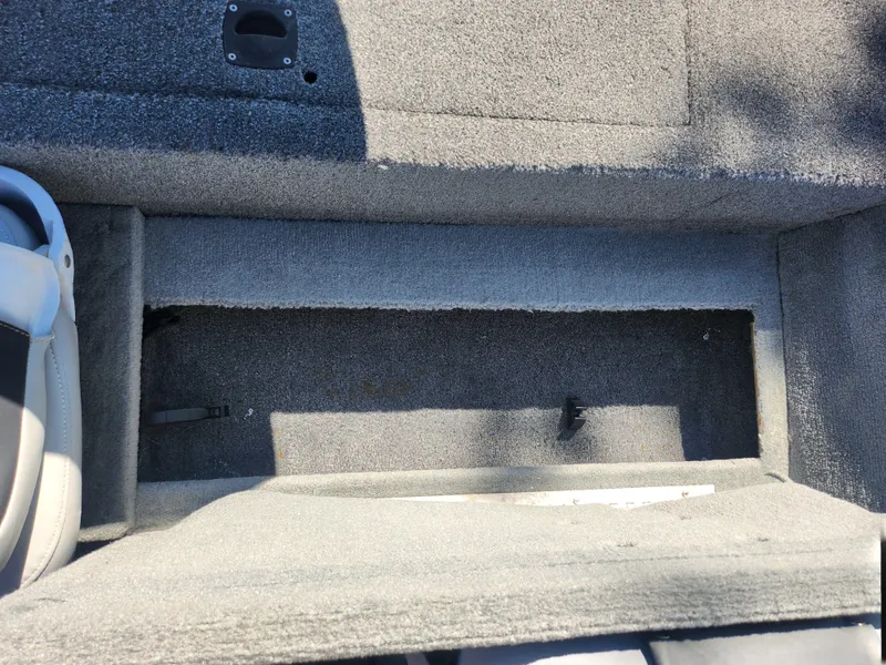 Slide: The Image of 2018 Tracker Pro 170 boat interior storage compartment with gray carpet. - 19