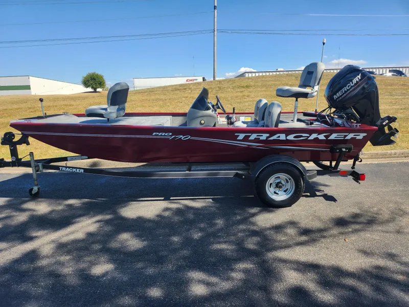 Slide: The Image of 2018 Tracker Pro 170 boat on trailer, red exterior, parked outdoors. - 4
