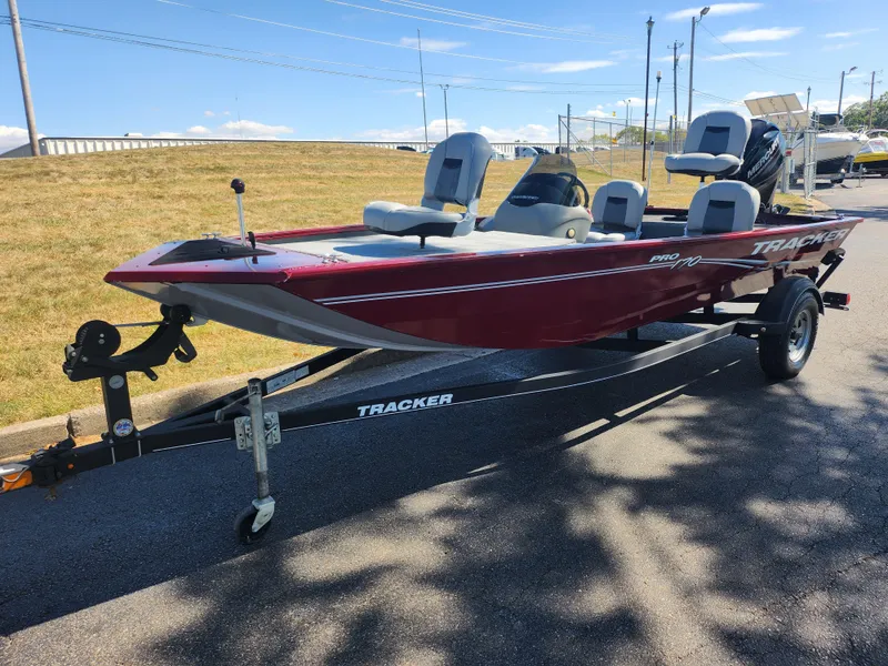Slide: The Image of 2018 Tracker Pro 170 boat on trailer, red exterior, parked on paved road. - 5