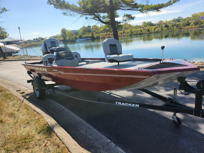 Slide: The Image of 2018 Tracker Pro 170 boat on trailer by a scenic lake. - 8