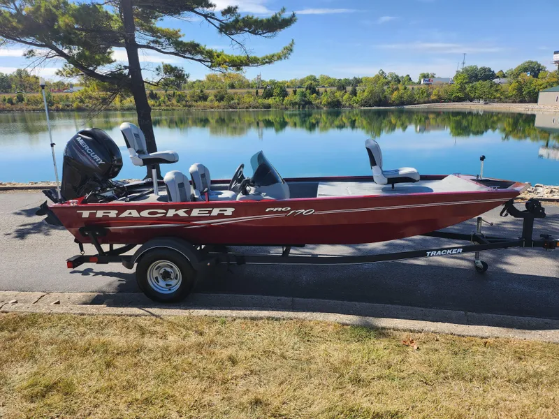 Slide: The Image of 2018 Tracker Pro 170 boat on trailer by a scenic lake. - 9