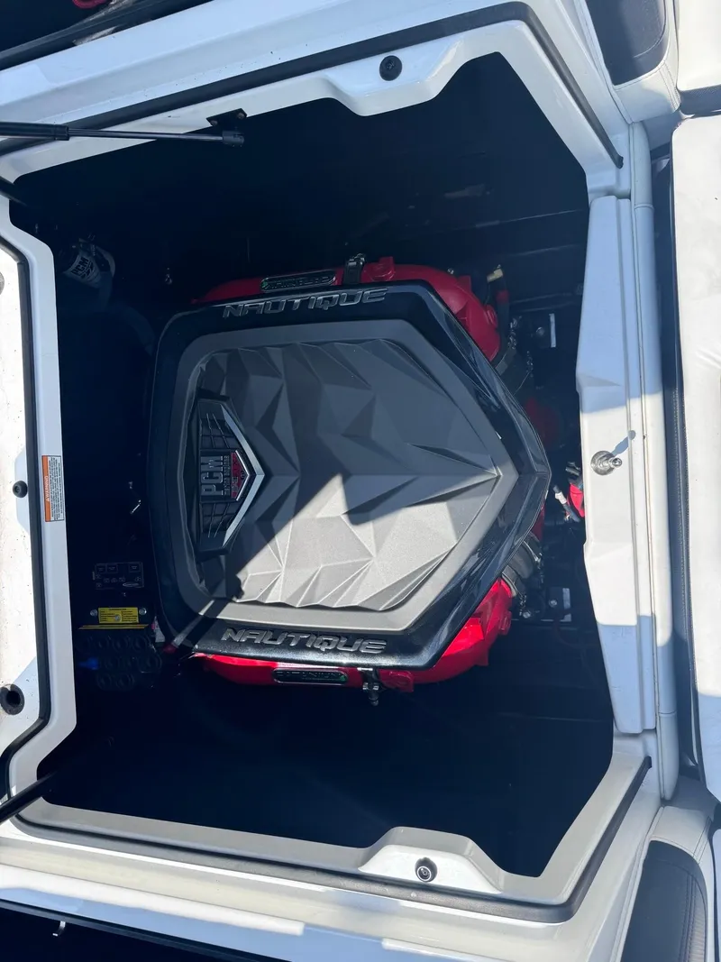Slide: The Image of 2018 Nautique G23 engine compartment with sleek design and branding. - 11