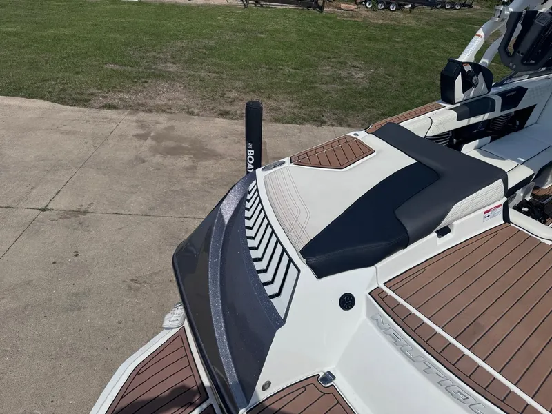 Slide: The Image of 2018 Nautique G23 boat with sleek design and wood-style deck. - 3