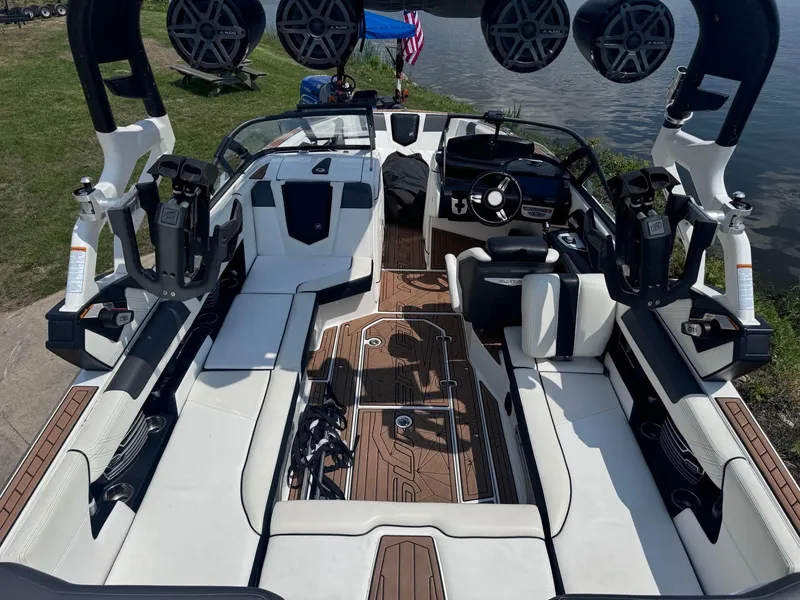 Slide: The Image of 2018 Nautique G23 boat interior with white seating and advanced sound system. - 5