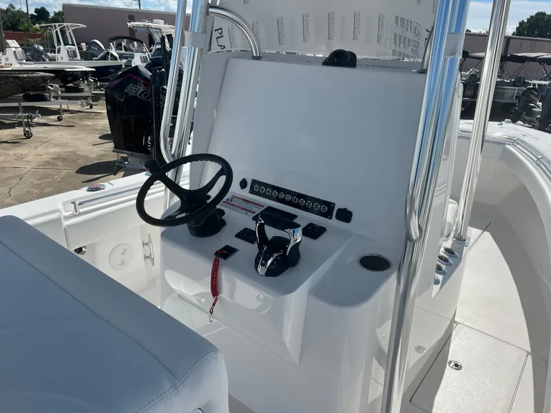 Slide: The Image of 2025 Contender 25T boat console with steering wheel and controls. - 16