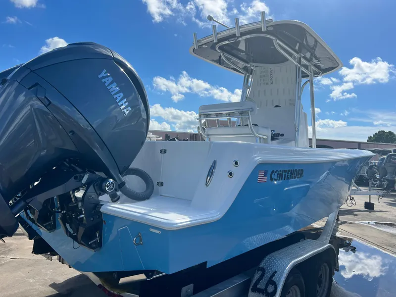 Slide: The Image of 2025 Contender 25T boat with Yamaha engine on trailer under blue sky. - 3