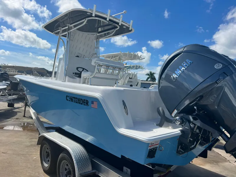 Slide: The Image of 2025 Contender 25T boat with Yamaha engine on trailer under blue sky. - 4