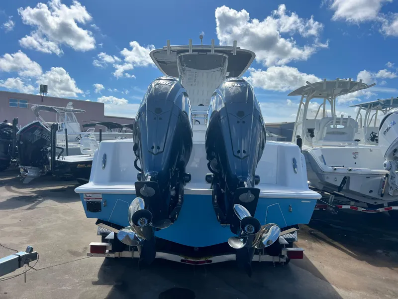 Slide: The Image of 2025 Contender 25T boat with dual outboard motors, displayed outdoors under a blue sky. - 5