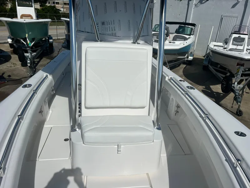 Slide: The Image of 2025 Contender 25T boat interior with white seating and console. - 8