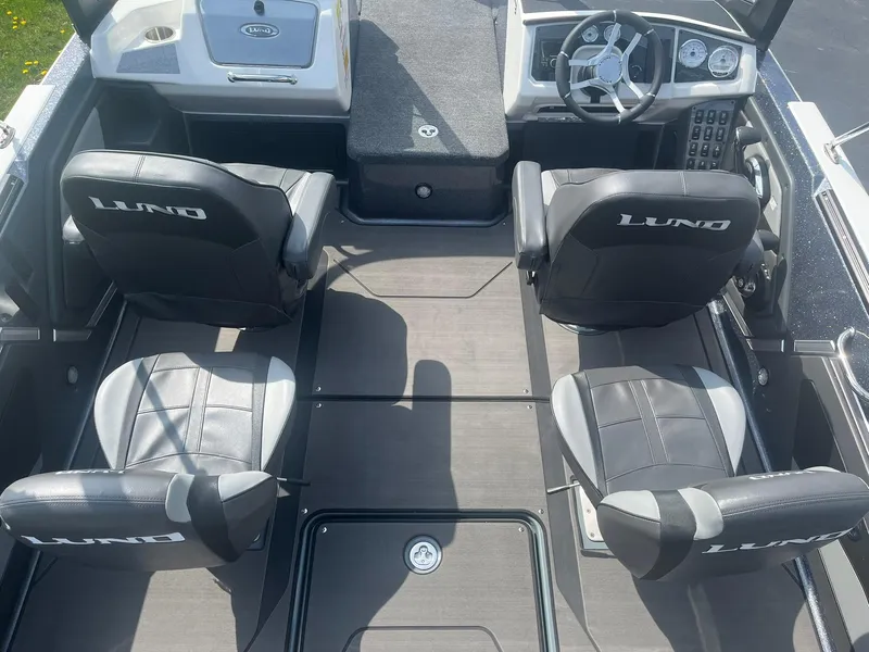 Slide: The Image of 2025 Lund 202 Pro-V GL boat interior with four seats and modern dashboard. - 11