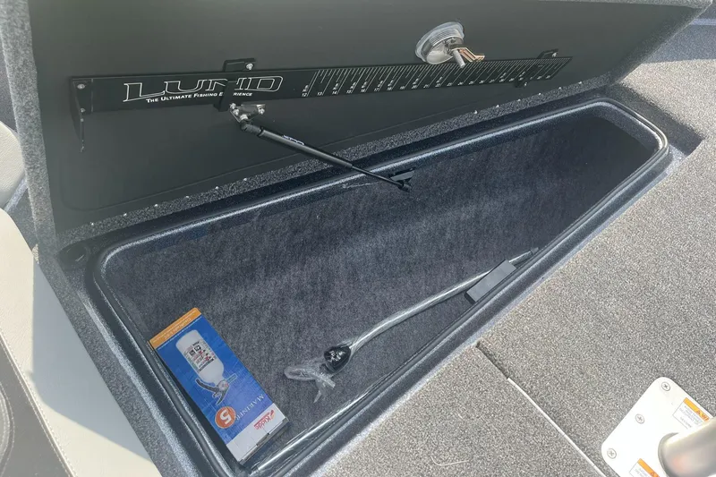 Slide: The Image of 2025 Lund 202 Pro-V GL boat storage compartment with hydraulic lift and accessory box. - 22