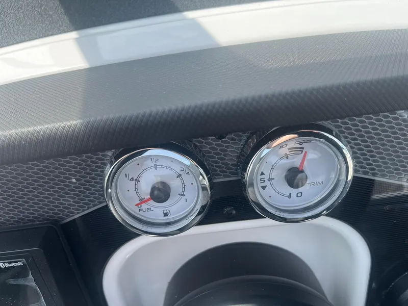Slide: The Image of Dashboard gauges of 2025 Lund 202 Pro-V GL boat, showing fuel and trim levels. - 27