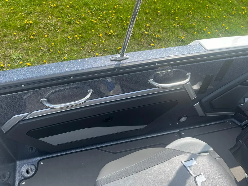 Slide: The Image of 2025 Lund 202 Pro-V GL boat interior with sleek design and comfortable seating. - 36