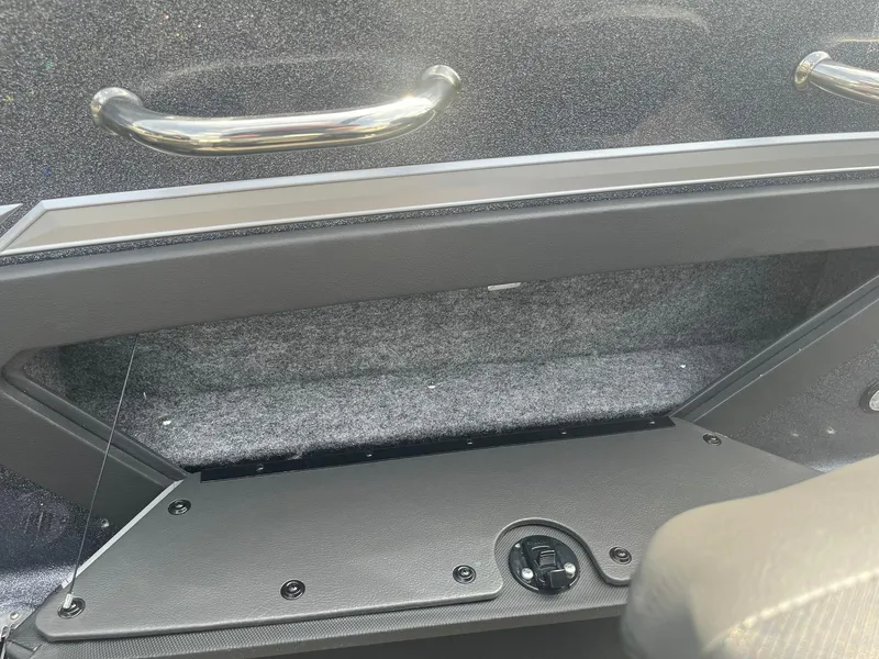 Slide: The Image of 2025 Lund 202 Pro-V GL boat storage compartment with sleek handles and textured interior. - 37