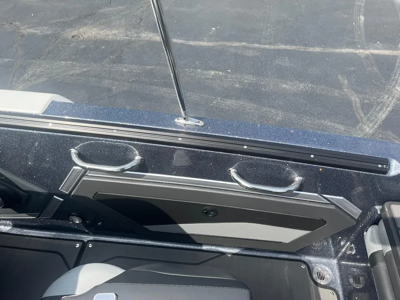 Slide: The Image of 2025 Lund 202 Pro-V GL boat interior with cup holders and sleek design. - 39