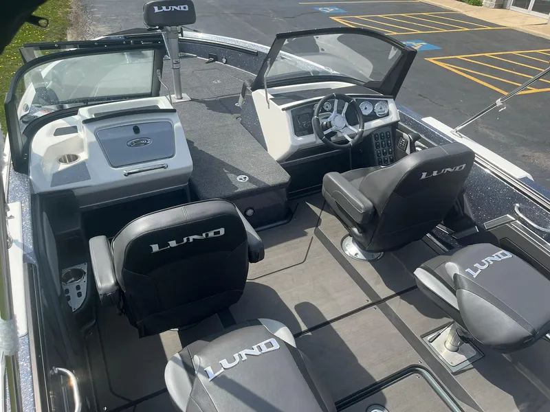 Slide: The Image of 2025 Lund 202 Pro-V GL boat interior with seating and dashboard, showcasing modern design and functionality. - 7