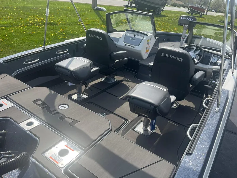 Slide: The Image of 2025 Lund 202 Pro-V GL boat interior with seating and dashboard, showcasing modern design and functionality. - 8