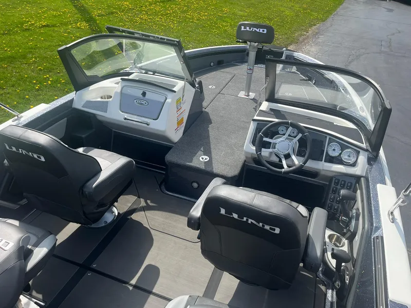 Slide: The Image of 2025 Lund 202 Pro-V GL boat interior with steering wheel and seating. - 9