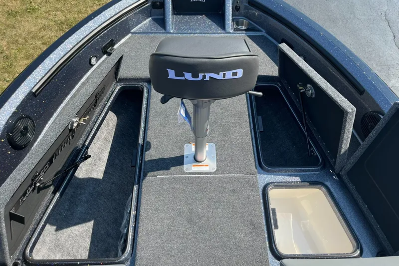 Slide: The Image of 2025 Lund 202 Pro-V GL boat interior with storage compartments and seating. - 13